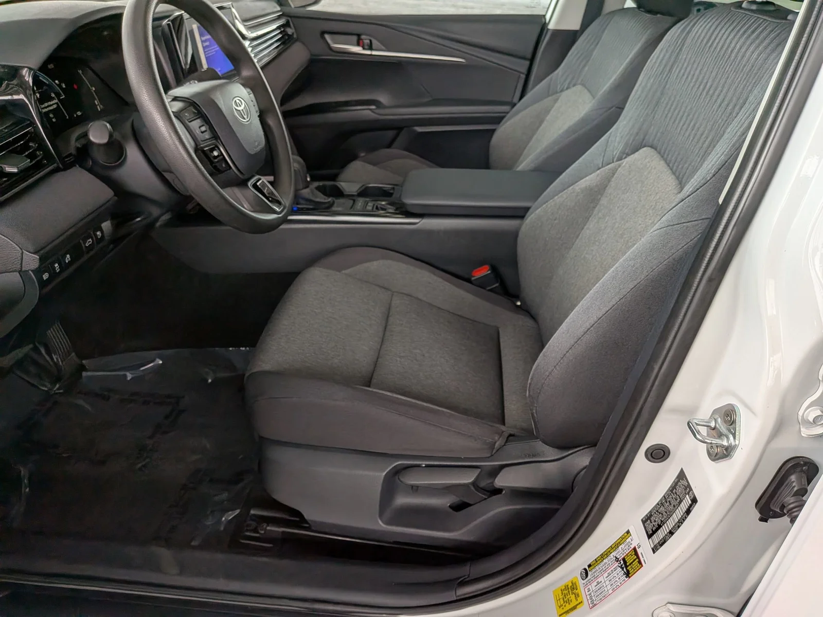 Front cloth seats and center console in a used Toyota Camry