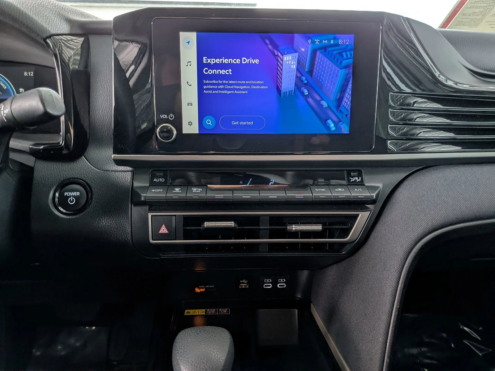 Center touchscreen with Drive Connect and climate controls in a used Toyota Camry