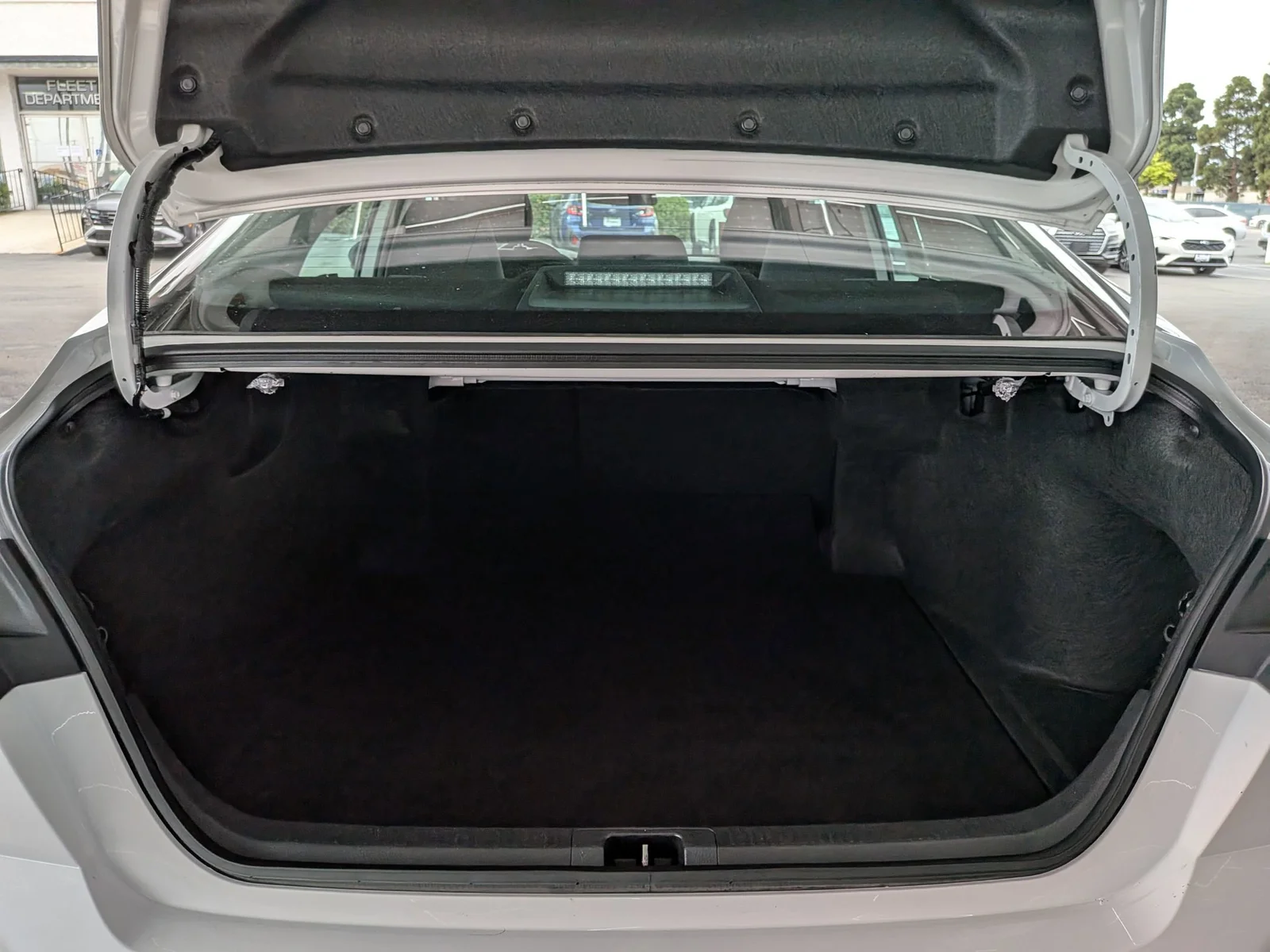 Open trunk of a used Toyota Camry showing the cargo area